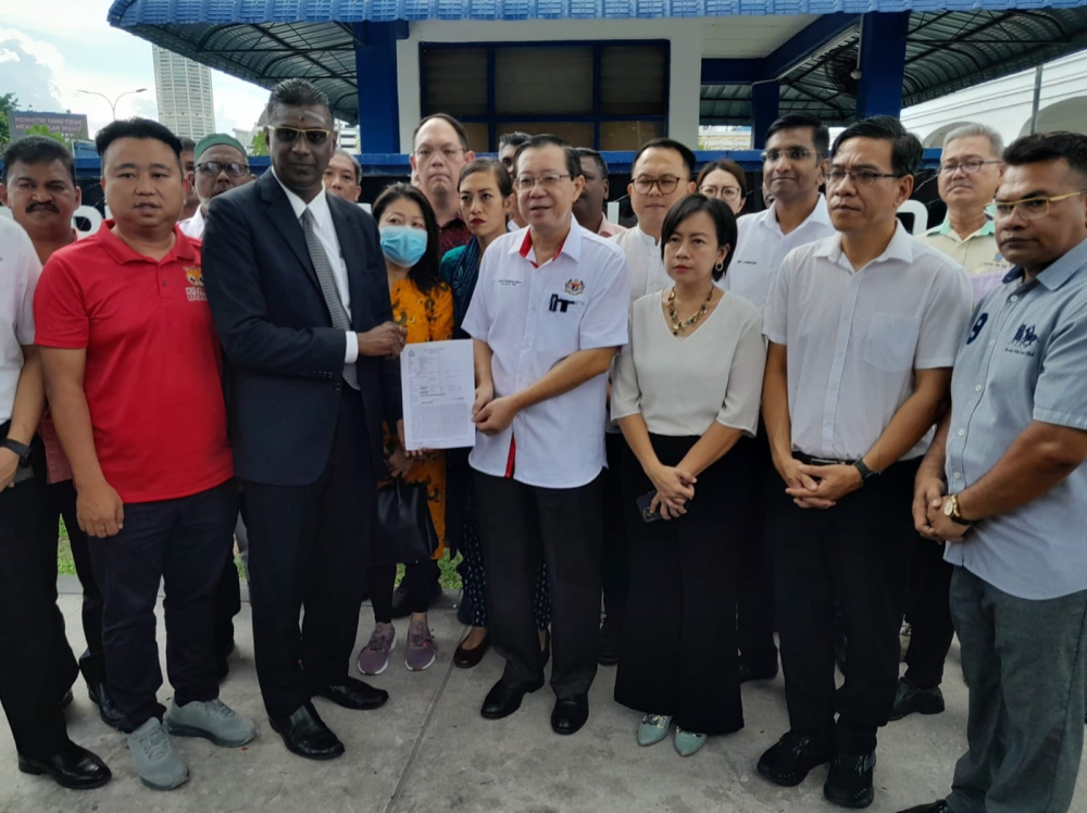 Rayer and Lim with other Penang MPs outside the police station. (Photo source Lim Guan Eng FB)