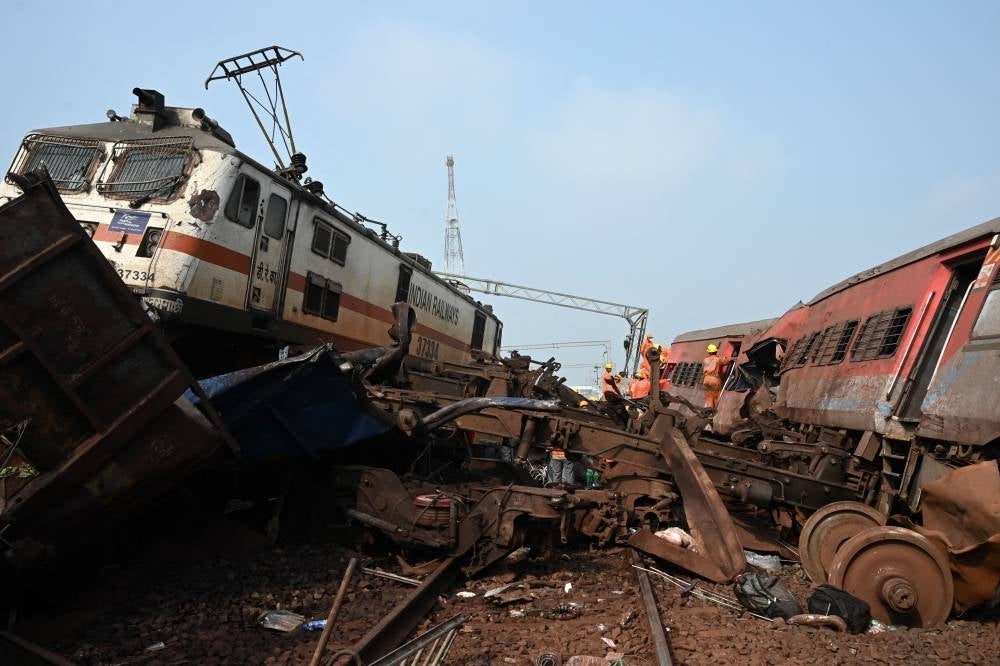 Rescue workers search for survivors amid damaged carriages at the accident site of a three-train collision near Balasore, about 200 km (125 miles) from the state capital Bhubaneswar in the eastern state of Odisha, on June 3, 2023. Photo by Dibyangshu Sarkar/AFP.
