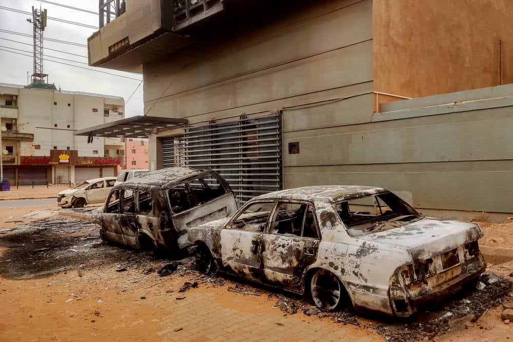 Destroyed vehicles are pictured outside the burnt-down headquarters of Sudan's Central Bureau of Statistics, on al-Sittin (sixty) road in the south of Khartoum on May 29, 2023. (Photo by AFP)