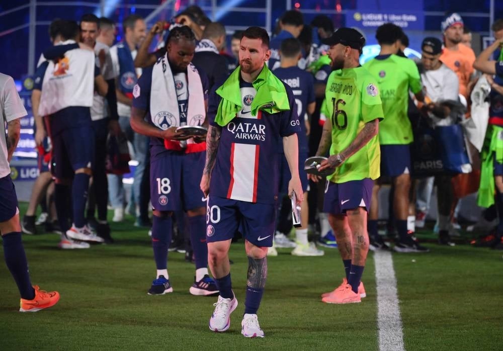Lionel Messi walks off the winners stand during the 2022-2023 Ligue 1 championship trophy ceremony following the L1 football match between Paris Saint-Germain (PSG) and Clermont Foot 63 at the Parc des Princes Stadium in Paris on June 3, 2023. - Photo by AFP