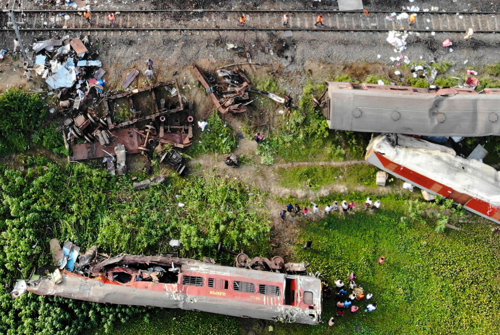This aerial view shows damaged carriages at the accident site of a three-train collision near Balasore, about 200 km (125 miles) from the state capital Bhubaneswar in the eastern state of Odisha, on June 4, 2023. - Photo by Punit PARANJPE / AFP