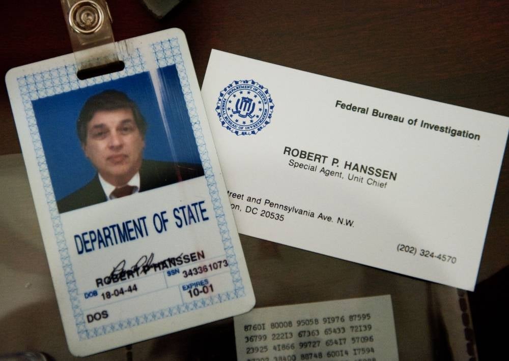 The identification and business card of former FBI agent Robert Hanssen are seen inside a display case at the FBI Academy in Quantico, Virginia, on May 12, 2009. Robert Hanssen, a former FBI agent who was sentenced to life in prison for being a Soviet and Russian spy, was found dead in his prison cell on June 5, 2023, according to US media sources - AFP 