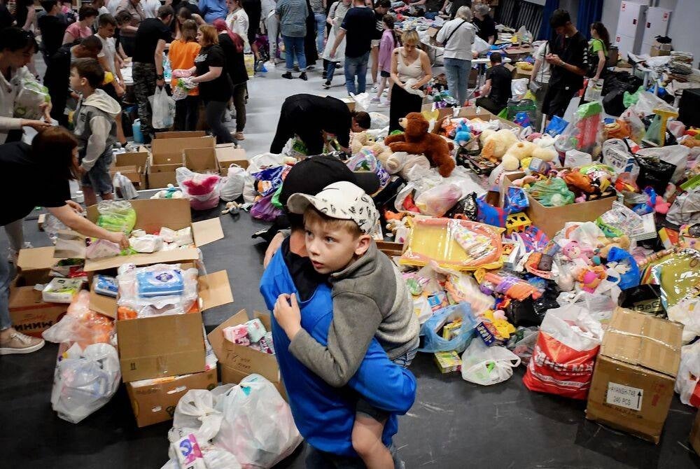 People evacuated from the Belgorod region's zones bordering Ukraine, including those from the town of Shebekino, receive humanitarian aid in Belgorod, on June 3, 2023. (Photo by Olga MALTSEVA / AFP)