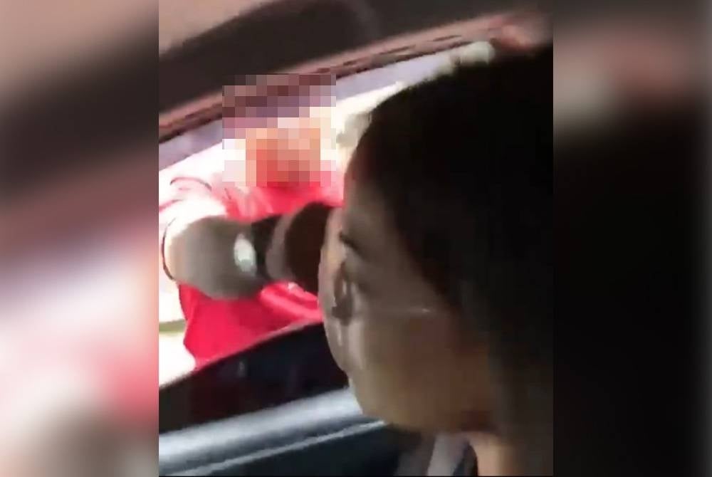 A screenshot of viral video of a man hitting the lady on the head