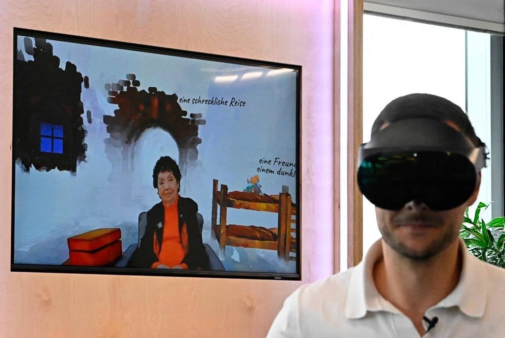 CORRECTION / A man wearing VR goggles is seen next to a screen depicting Holocaust survivor Inge Auerbacher at the Meta hub in Berlin on June 6, 2023. Inge Auerbacher fears for a future when Holocaust survivors like her can no longer bear witness. But advances in virtual reality and AI give her hope their stories will live on. Auerbacher, 88, is the star of a new interactive VR experience called "Tell Me, Inge" in which she recounts her horrific experiences as a small Jewish child in a Nazi concentration camp and what it took for her to not give up.
StoryFile co-founder Stephen Smith, who has worked in Holocaust education for three decades, said the technology allows users to "talk to history through the people who went through it". (Photo by Tobias SCHWARZ / AFP) / “The erroneous mention[s] appearing in the metadata of this photo by Tobias SCHWARZ has been modified in AFP systems in the following manner: [Holocaust survivor Inge Auerbacher ] instead of [Holocaust survivor Inger Auerbacher ]. Please immediately remove the erroneous mention[s] from all your online services and delete it (them) from your servers. If you have been authorized by AFP to distribute it (them) to third parties, please ensure that the same actions are carried out by them. Failure to promptly comply with these instructions will entail liability on your part for any continued or post notification usage. Therefore we thank you very much for all your attention and prompt action. We are sorry for the inconvenience this notification may cause and remain at your disposal for any further information you may require.”