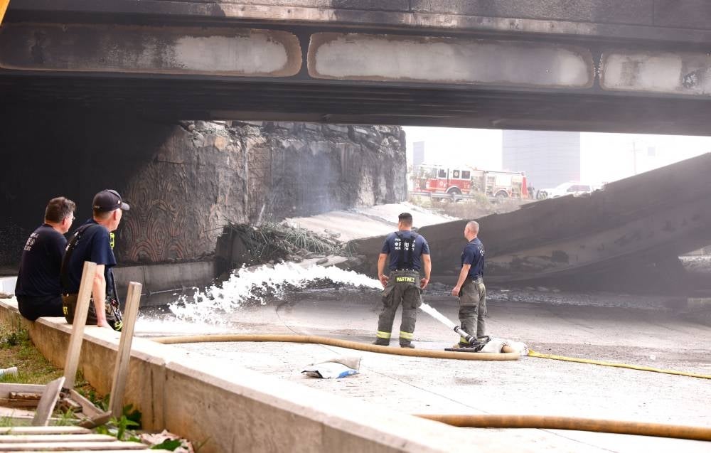 Firefighters work at a collapsed portion of Interstate 95, caused by a large vehicle fire, in Philadelphia, Pennsylvania, on June 11, 2023. Photo by Kena Betancur/AFP.