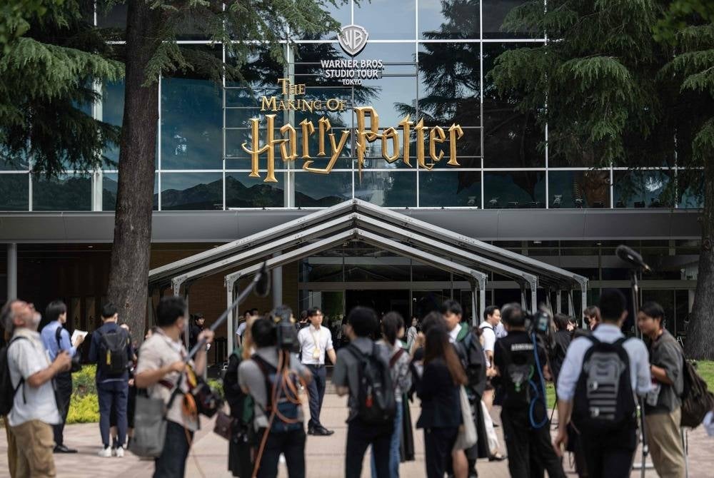 Members of media gather at the entrance of the theme park "Warner Bros. Studio Tour Tokyo - The Making of Harry Potter" in Tokyo on June 16, 2023. (Photo by Yuichi YAMAZAKI / AFP)