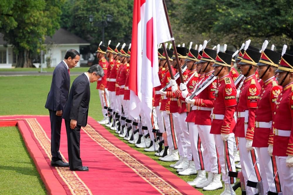 Japanese Emperor Naruhito (C) accompanied by Indonesian President Joko Widodo (L) inspect an honor guard upon his arrival at the Presidential Palace in Bogor on June 19, 2023 - AFP 