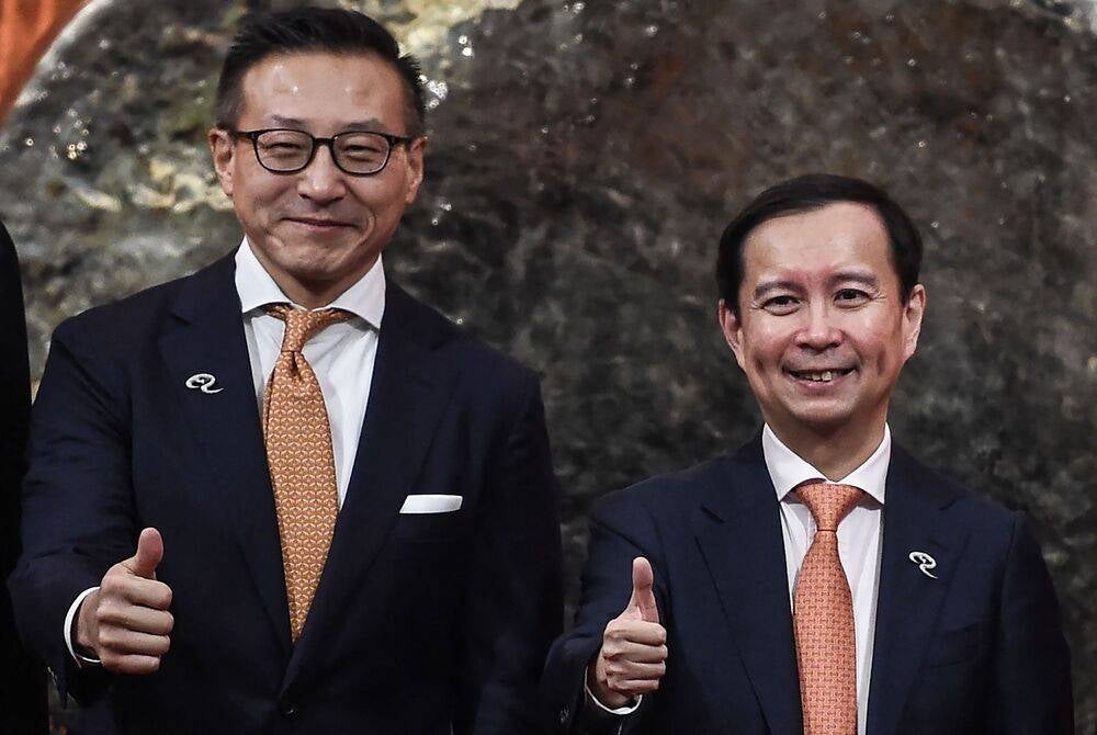 (FILES) Alibaba Group independent non-executive director Daniel Zhang (R) and Joseph Tsai, co-founder and executive vice chairman of Alibaba Group, attend the company's stock trading debut at the headquarters of the Hong Kong Exchanges and Clearing in Hong Kong on November 26, 2019. Chinese tech giant Alibaba announced on June 20, 2023 that it will replace chairman and CEO Daniel Zhang with current executive vice chairman Joseph Tsai in September. (Photo by Ye Aung THU / AFP)