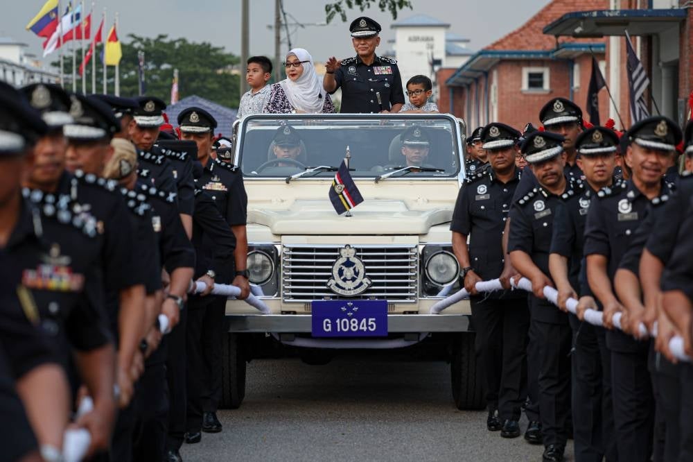 Final send-off for outgoing IGP Tan Sri Acryl Sani on a police open top ceremony vehicle at Pulapol. Acryl thanked the media for being the bridge between the police and public. - Photo by Bernama