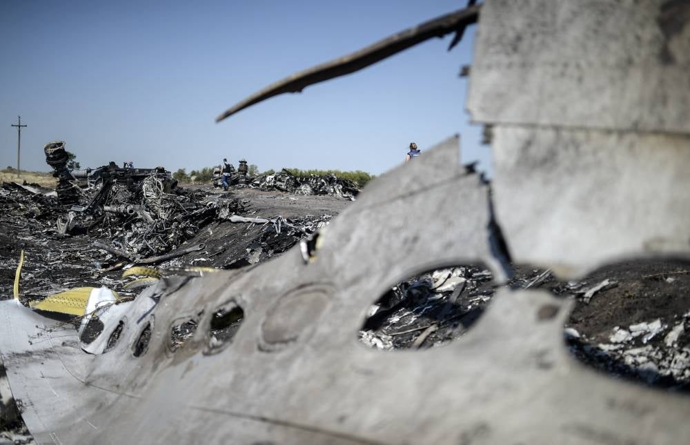 A part of the Malaysia Airlines Flight MH17 at the crash site in the village of Hrabove (Grabovo), some 80km east of Donetsk, on August 2, 2014. Photo by Bulent Kilic/AFP FILE PIX