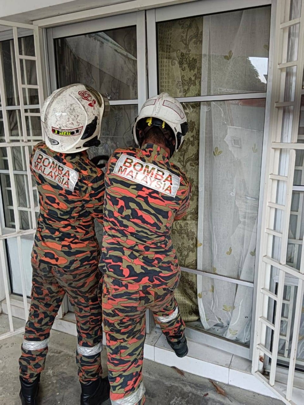 Firemen opening the locked house with special equipment 