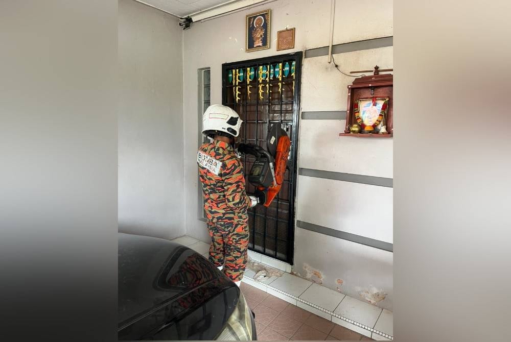 Firemen used special equipment to open the door of the house where the 77-year-old elderly man lived. - Photo courtesy of Bomba Perak