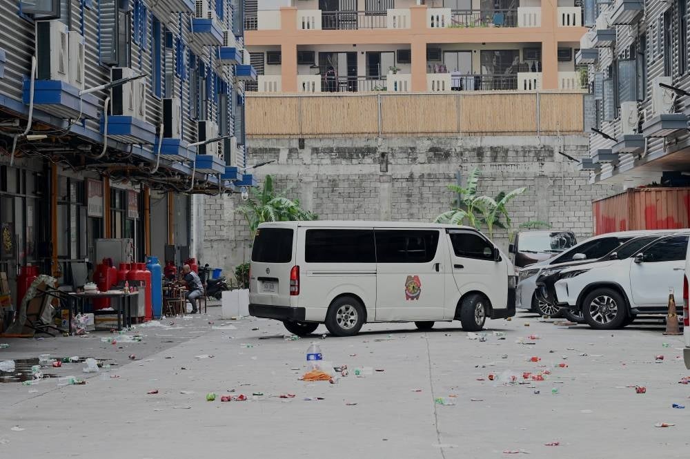 A police van arrives inside a compound, where police raided buildings in Metro Manila on June 27, 2023. - (Photo by JAM STA ROSA / AFP)