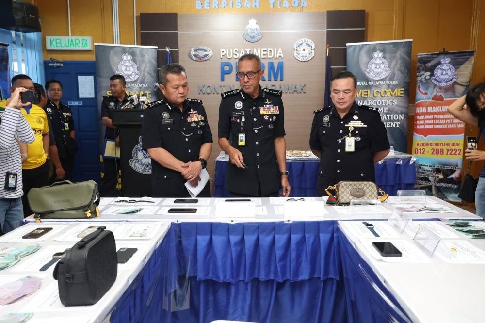 Sarawak police commissioner Datuk Mohd Azman Ahmad Sapri showing among the items seized in a press conference, today. - Photo by Bernama