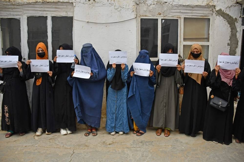 Afghan women hold placards demanding their right to education, in Mazar-i-Sharif on June 26, 2023. - (Photo by ATIF ARYAN / AFP)