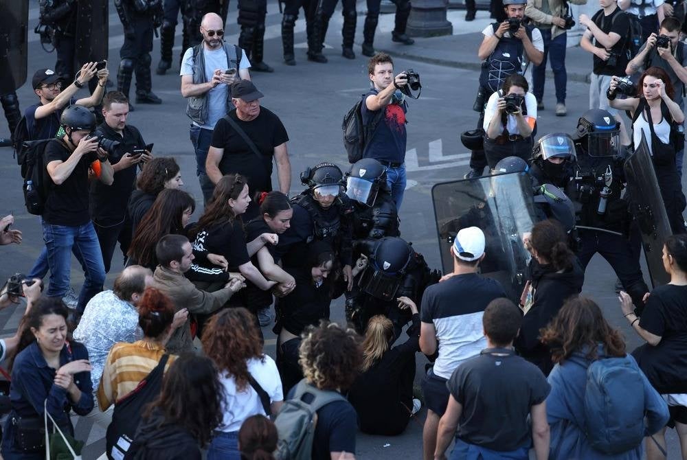 Police officers detain a protester during a demonstration at Place de la Concorde in Paris on June 30, 2023, over the shooting of a teenage driver by French police in a Paris suburb on June 27. (Photo by CHARLY TRIBALLEAU / AFP)