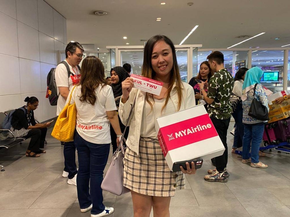 Beatrice Lim 33, from Subang Jaya shows her free return flight from Kuala Lumpur to Tawau from MYAirline. Picture by Nurul Atikah Sarji