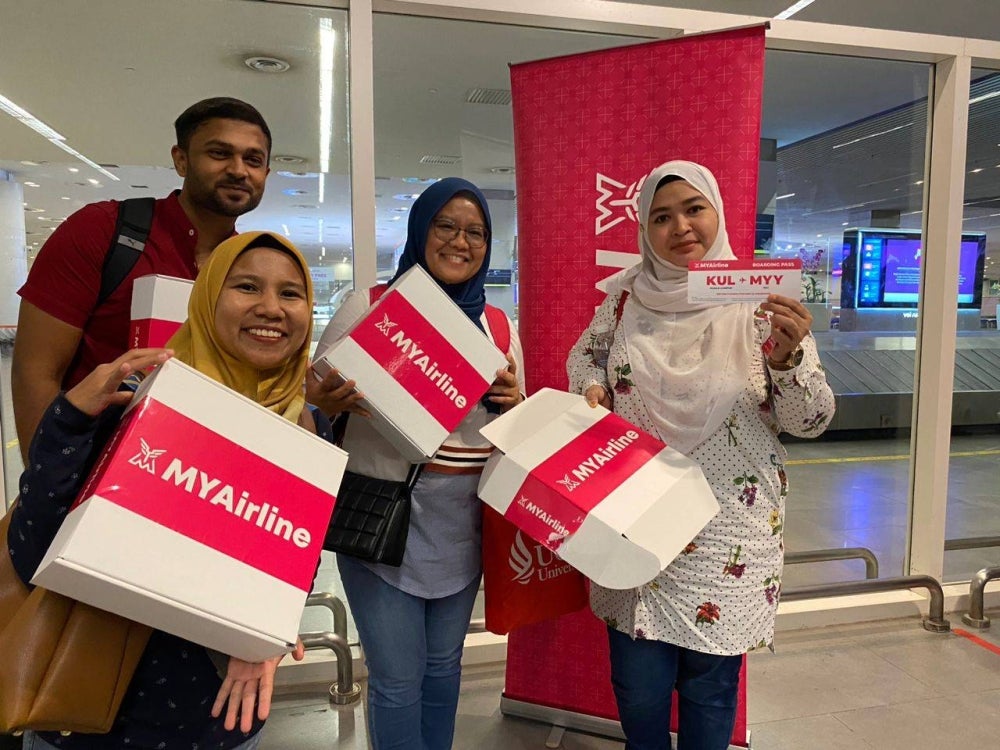 The passengers on flight Z98104, en route from Kuching to Kuala Lumpur got excited gifts. Picture by Nurul Atikah Sarji