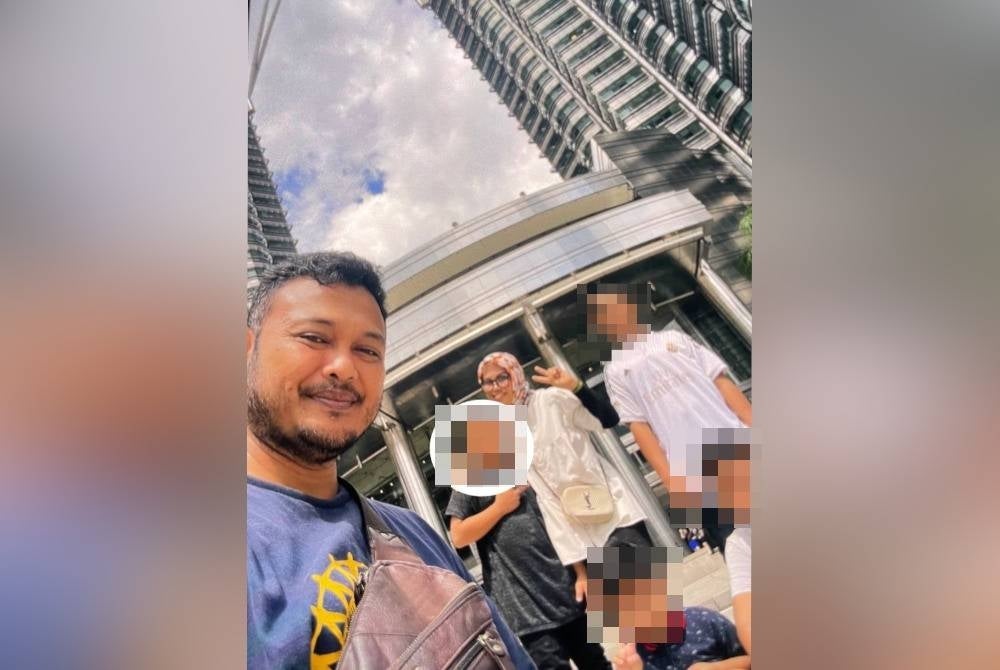 The deceased (in grey shirt) with his family on vacation in Kuala Lumpur recently - FILE PIX 