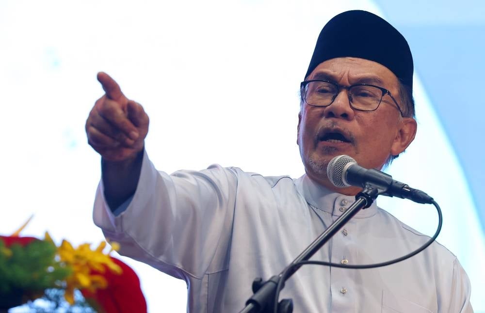 Prime Minister Datuk Seri Anwar Ibrahim delivering a speech during the 2023 Felda Settlers’ Day celebration today. - Photo by Bernama