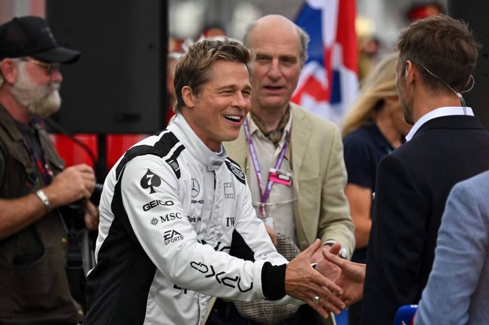 US actor Brad Pitt, starring as an driver in an F1-inspired movie, is seen prior to the Formula One British Grand Prix at the Silverstone motor racing circuit in Silverstone, central England - AFP 