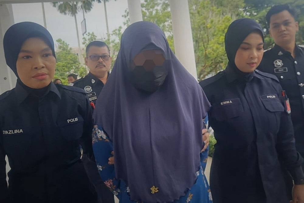 The woman who was clad in a blue 'jubah' (robe) arrived at the court's compound at 9am escorted by policewomen.