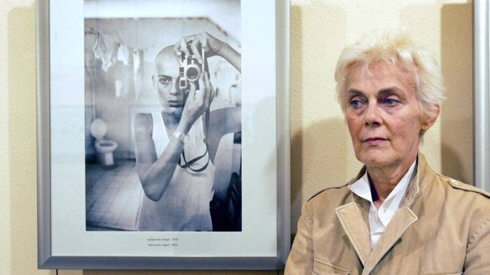 Marie-Laure de Decker photgraphed celebrities at home and conflicts abroad. Seen here in 2006 in front of a self-portrait. - (Photo by ERIC CABANIS / AFP)