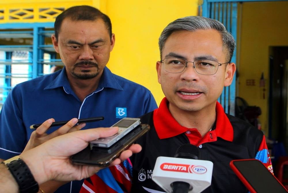 Communications and Digital Minister Fahmi Fadzil (right) - BERNAMA