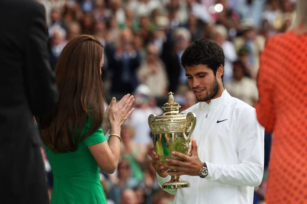 Britain's Catherine, Princess of Wales, presents the winner's trophy to Spain's Carlos Alcaraz after beating Serbia's Novak Djokovic during their men's singles final tennis match on the last day of the 2023 Wimbledon Championships. - Photo by Adrian Dennis / AFP