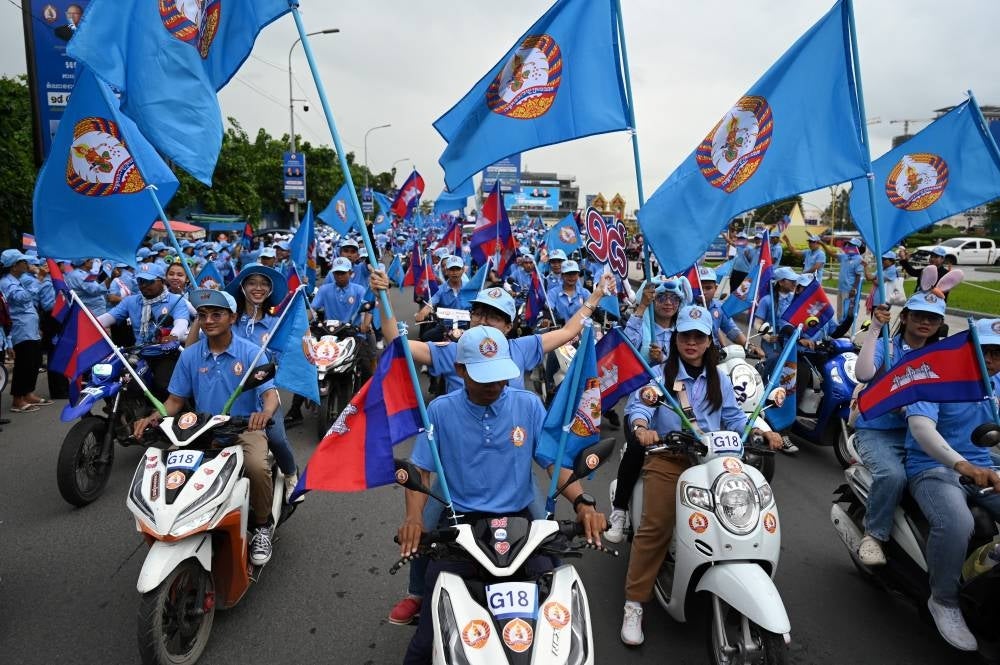 Supporters of Cambodian People’s Party (CPP) participate during a campaign rally in Phnom Penh on July 21, 2023. - (Photo by TANG CHHIN SOTHY / AFP)