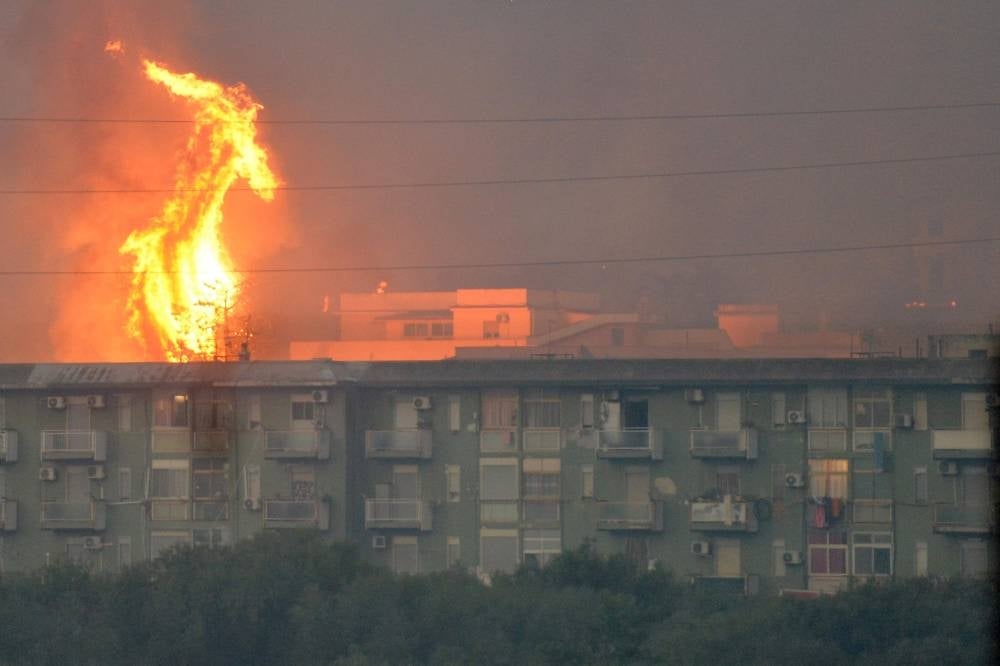 This photo obtained from Italian news agency Ansa shows a vast fire spreading on hills in the area of Monte Grifone and the town of Ciaculli around Palermo, Sicily. - Photo by Ansa / AFP