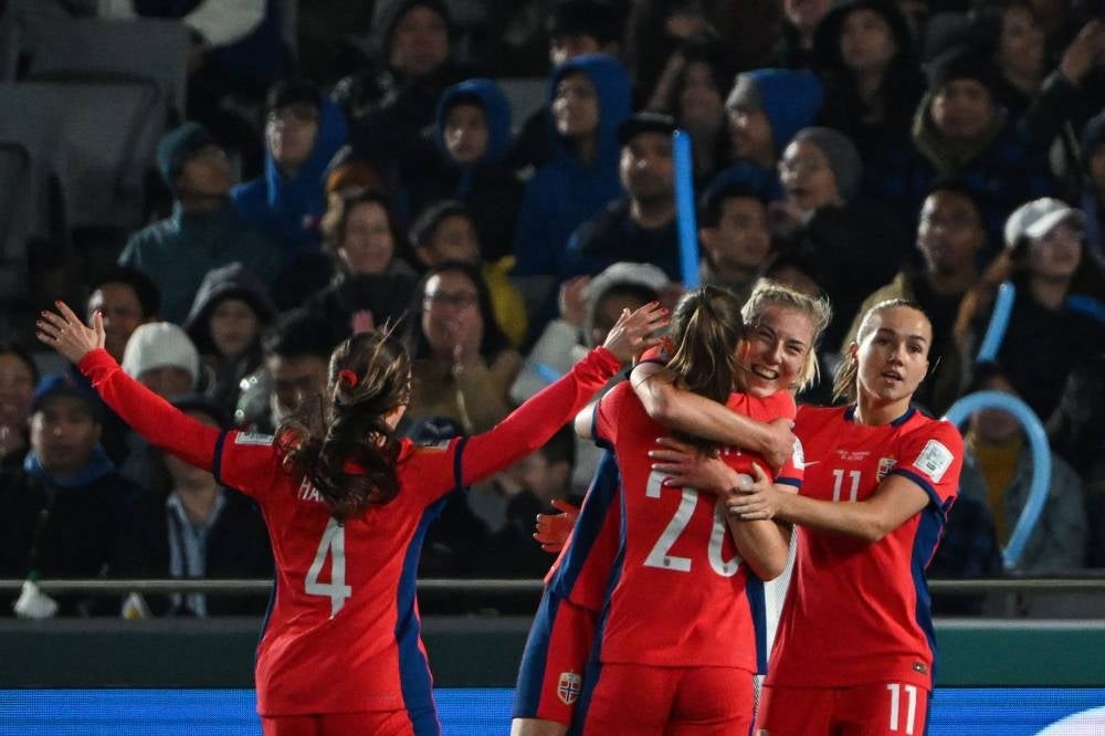 Norway's forward #22 Sophie Roman Haug celebrates with her teammates after scoring her team's second goal during the Australia and New Zealand 2023 Women's World Cup Group A football match between Norway and the Philippines at Eden Park in Auckland on July 30, 2023. (Photo by Saeed KHAN / AFP)