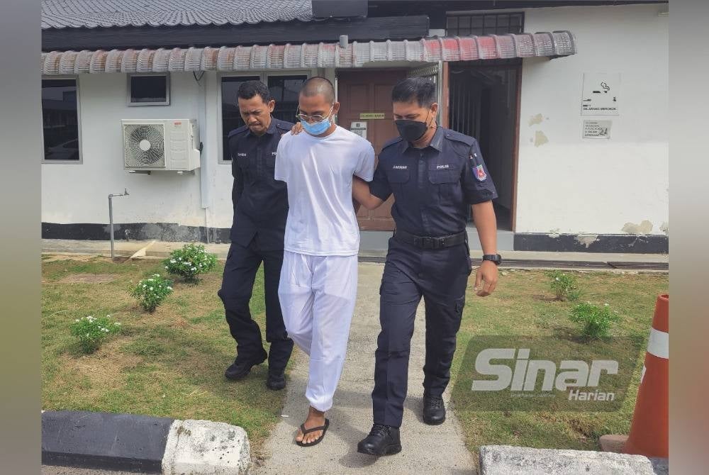 Muhammad Fakrul Aiman (centre) escorted by police to the Sungai Besar magistrate's court on Thursday.