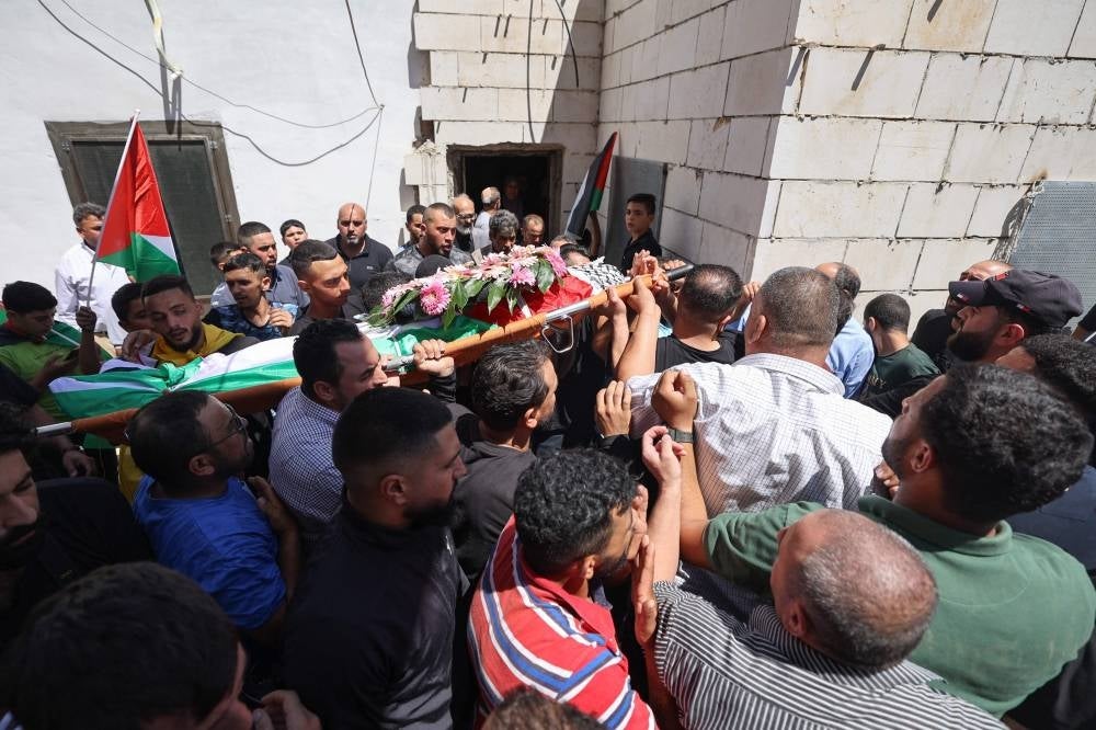 Mourners carry the body of 19-year-old Palestinian Qusai Jamal Maatan, during his funeral in the village of Burqa in the north of the occupied West Bank on Aug 5, 2023. (Photo by Jaafar ASHTIYEH / AFP)