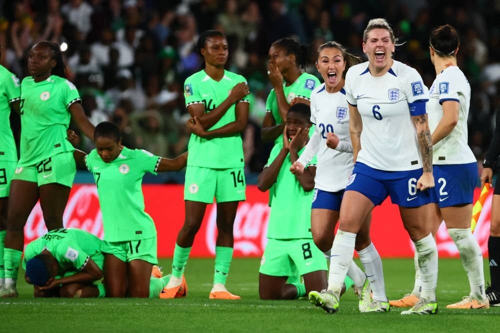 England's players celebrate their victory after a penalty shoot-out during the Australia and New Zealand 2023 Women's World Cup round of 16 football match between England and Nigeria at Brisbane Stadium in Brisbane on August 7, 2023. (Photo by Patrick Hamilton / AFP)