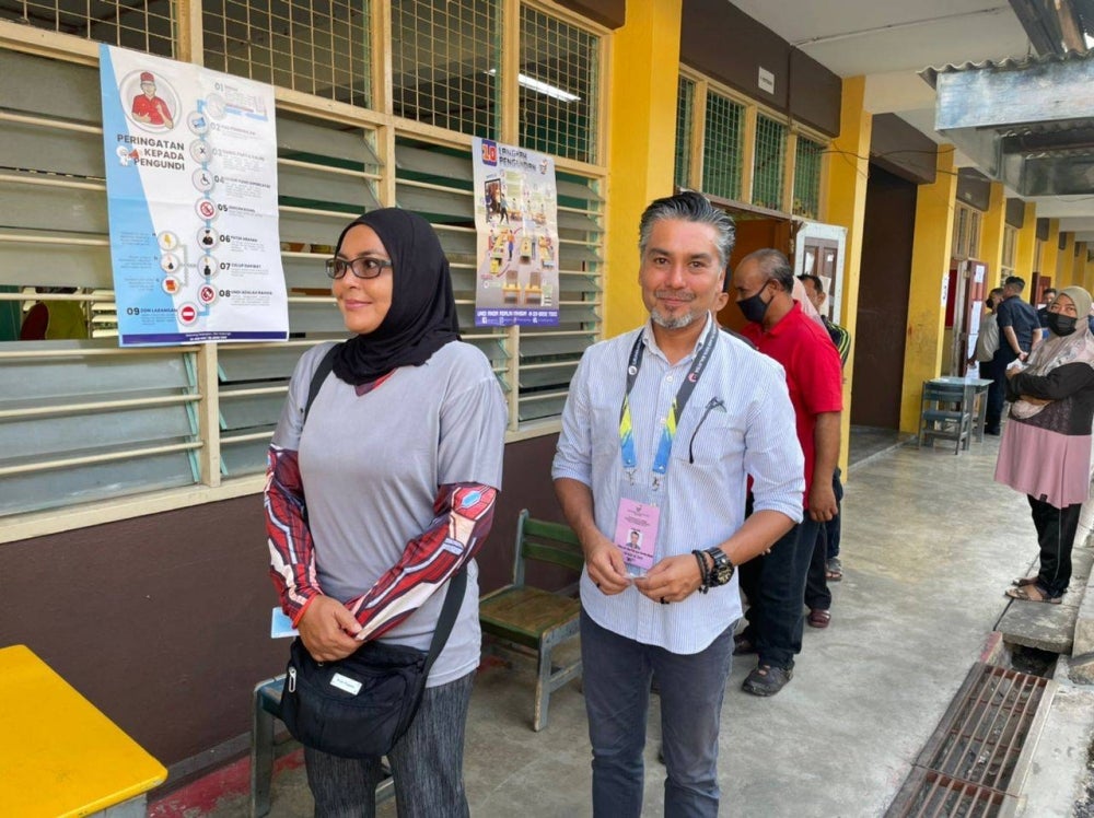 Khaliq was accompanied by his sister Azlina Mehtab, 52, and they both showed their inked fingers at 8.30am. - Photo by Nurul Atikah Sarji