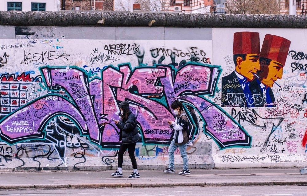 Graffiti art on a remaining section of Berlin Wall. Photo for illustration purposes only. 