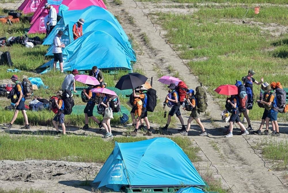 TOPSHOT - Scouts prepare to leave the campsite of the World Scout Jamboree in Buan, North Jeolla province on August 8, 2023. Organisers of the World Scout Jamboree asked host South Korea on Aug 7 to "urgently" evacuate tens of thousands of children from their campsite ahead of a typhoon, just days after a heatwave caused mass scout illnesses. (Photo by Anthony WALLACE / AFP)