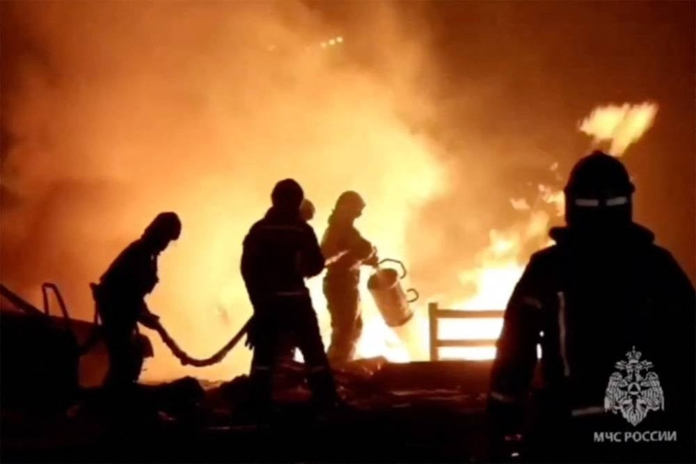 In this handout video grab taken from a footage released by Russian Emergency Ministry on Aug 14, 2023, rescuers put out a fire at a gas station in the city of Makhachkala Tuesday. - (Photo by RUSSIAN EMERGENCY MINISTRY / AFP)
