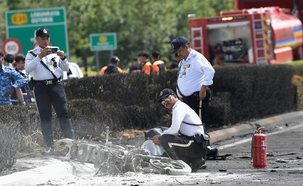 Authorities at the scene of the crash, inspecting the motorcycle that the plane collided into - FILE PIX 