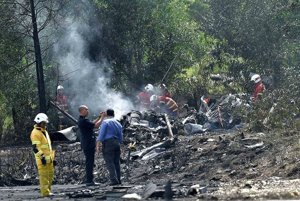 Members of the Malaysian Fire and Rescue Department (JBPM) trying to put out the fire at the scene of the plane crash in Elmina Shah Alam on Thursday.