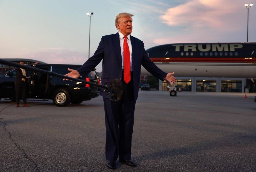 Former US President Donald Trump speaks to the media at Atlanta Hartsfield-Jackson International Airport after surrendering at the Fulton County jail on August 24, 2023 in Atlanta, Georgia. - Photo by AFP