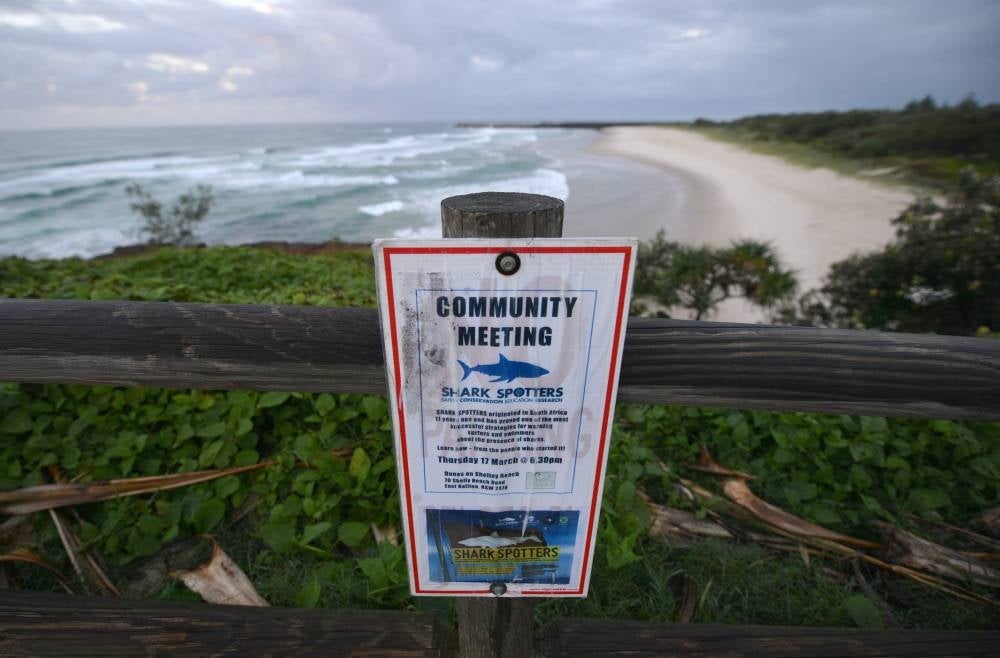 This photo taken on April 29, 2016 shows a sign about a shark spotters meeting at Lighthouse Beach in Ballina in northern New South Wales. - Photo by AFP
