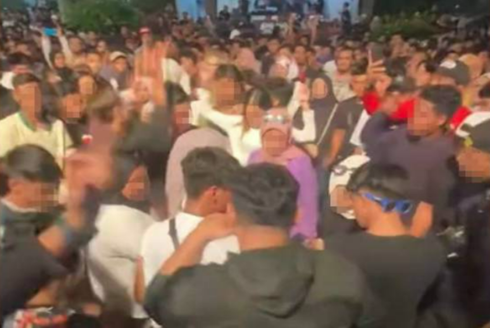 A screenshot of a viral video showing a group of male and female spectators dancing inappropriately.