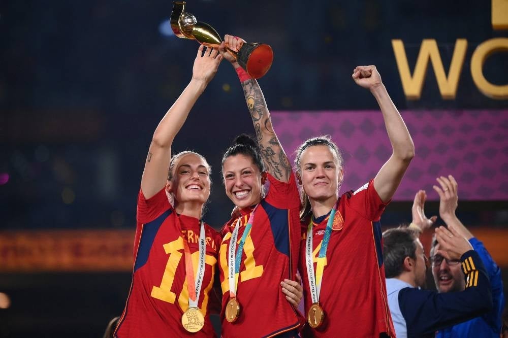 Spain's midfielder #10 Jennifer Hermoso, midfielder #11 Alexia Putellas and defender #04 Irene Paredes celebrate with the trophy after winning the Australia and New Zealand 2023 Women's World Cup final football match between Spain and England. Photo by Franck Fife/AFP FILE PIX