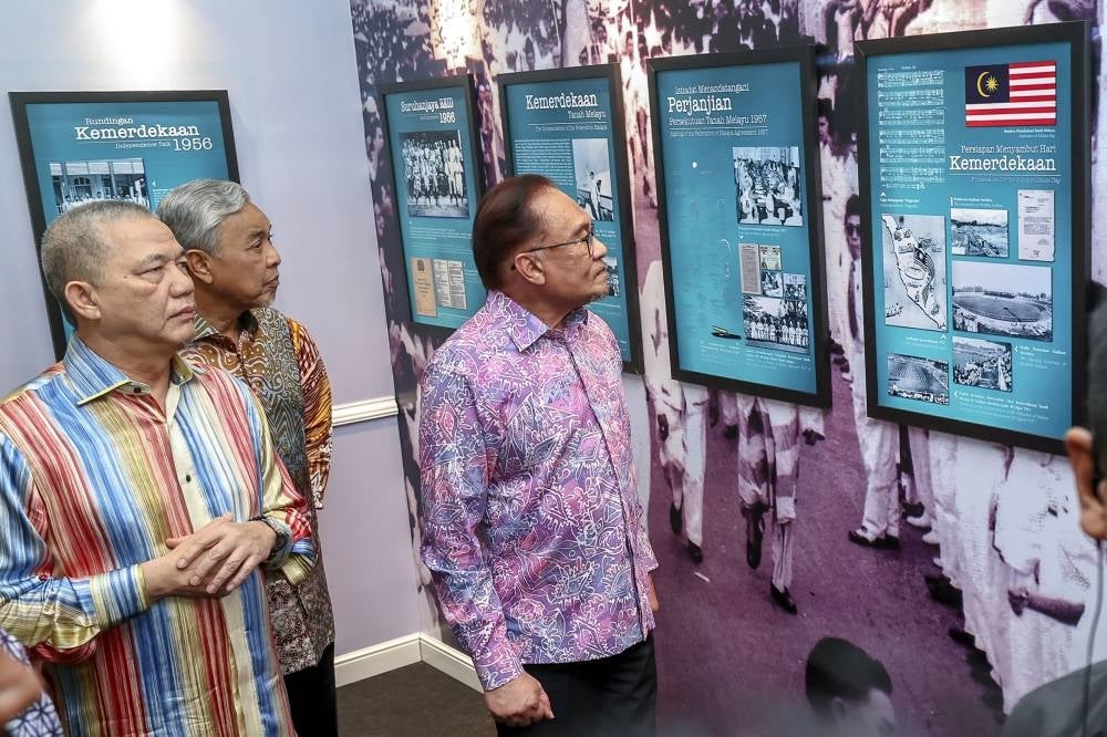 Prime Minister, Datuk Seri Anwar Ibrahim (right), during a visit to the Independence exhibition with Deputy Prime Minister, Datuk Seri Zahid Hamidi (second from left), and Datuk Seri Fadillah Yusof (left), at the Prime Minister's Address event for National Day at PICC. - BERNAMA PIX