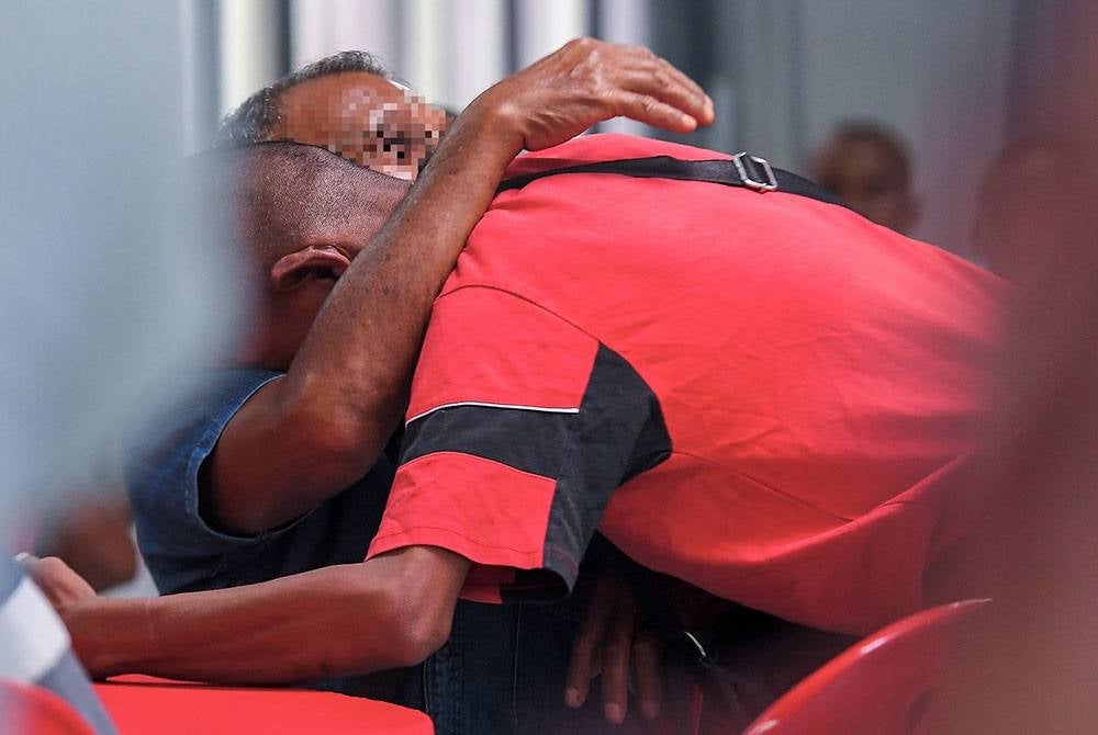 An inmate known as Amir (not his real name) hugging his family member after receiving the release document. - BERNAMA PIX