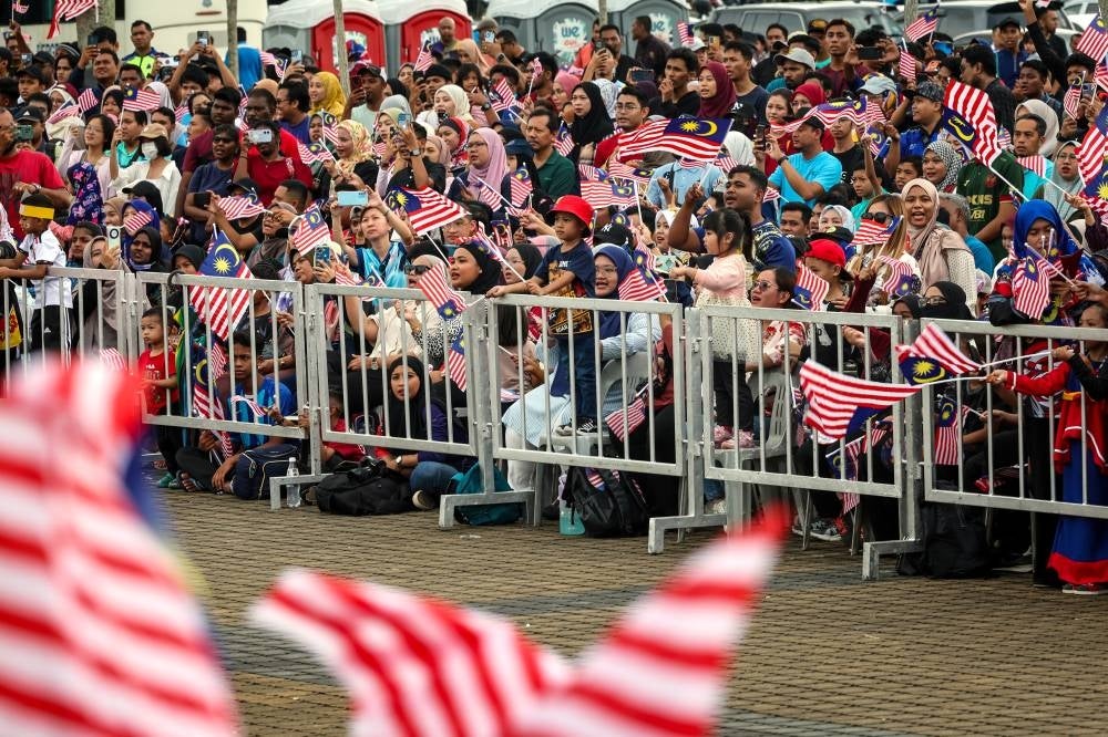 The public celebrating the parade for the 66th National Day celebrations in Stadium Batu Kawan on Thursday. - BERNAMA PIX
