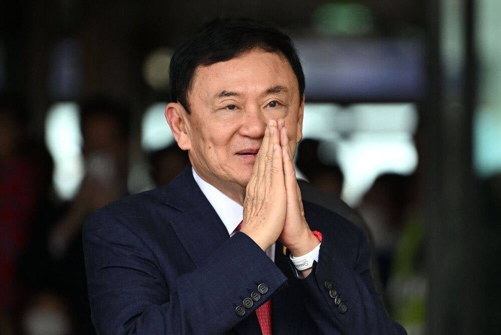 (FILES) Former Thai Prime Minister Thaksin Shinawatra greets his supporters after landing at Bangkok's Don Mueang airport on Aug 22, 2023. (Photo by Manan VATSYAYANA / AFP)